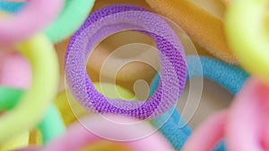 vertical shot of a vibrant colors rotating close up rubber bands