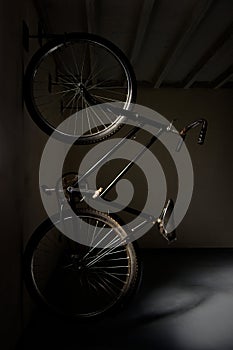 Vertical shot of a vintage bicycle parked in a dark garage