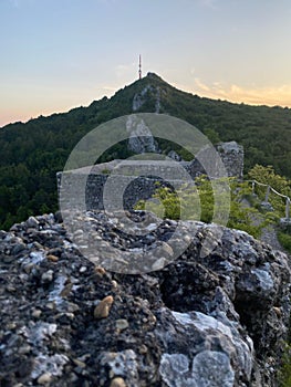 Vertical shot of Vrsatec castle ruins in green mountains of Slovakia at sunset