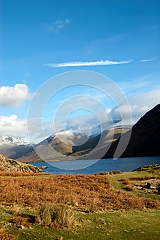 Vertical shot of the Wastwater lake in Wasdale with snow-covered Scafell mountain in the distance