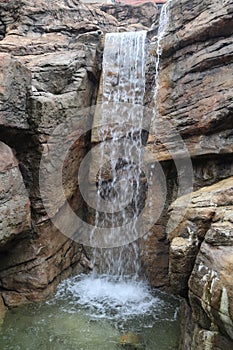 Vertical shot of a waterfall at a luxury resort in Asheville, North Carolina.
