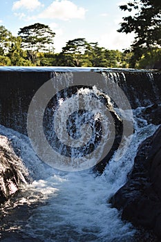 Vertical shot of a waterfall in the wild nature. Hawaii.