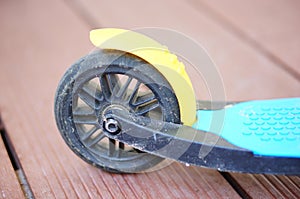 Vertical shot of a wheel of children's tricycle scooter