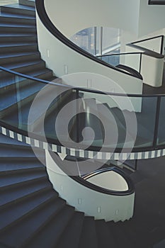 Vertical shot of a white and black spiral staircase