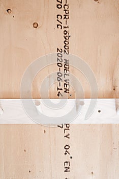 Vertical shot of white Hangars on bright wooden wall with text on it
