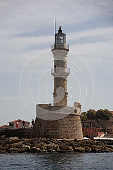 Vertical shot of the white Lighthouse of Chania by the sea in Chania, Crete, Greece