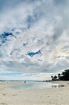 Vertical shot of a white sand beach on a cloudy sky at Bantayan Island in Cebu, Philippines