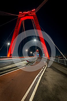 Vertical shot of the Willemsbrug or Williams Bridge in Rotterdam, Netherlands at night