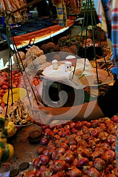 Vertical shot of a woman selling dried fish at a weekly market on Inle Lake,  Myanmar (Burma)