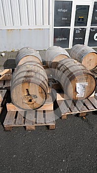 Vertical shot of wooden barrels outside a microbrewery factory in Iceland