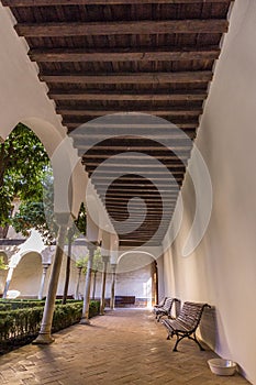 Vertical shot of wooden benches in Espacio Santa Clara in Seville, Spain photo