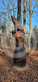 Vertical shot of a wooden carving of a wolf at Crawford Lake