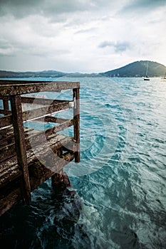 Vertical shot of a wooden dock at the Lake Attersee, Austria