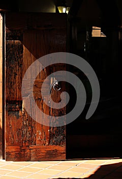 Vertical shot of a wooden door covered in a shadow