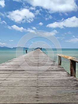 Vertical shot of a wooden pier over a sea