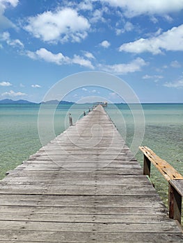 Vertical shot of a wooden pier over a sea