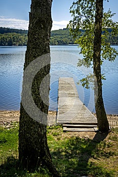 Vertical shot of a wooden pontoon on lake Vassiviere, Creuse and Haute Vienne departments, France