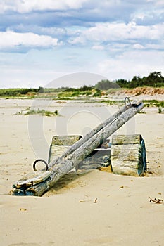 Vertical shot of a wooden teeter totter in the beach