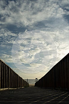 Vertical shot of the wooden walkway to the beach