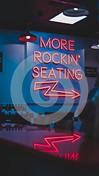 Vertical shot of the words More Rockin' Seating and an arrow on a wall