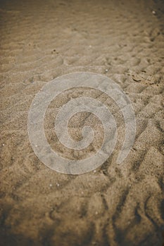 Vertical shot of wrinkles on the sand of the beach