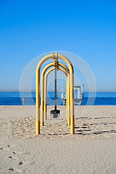 Vertical shot of a yellow swing in the world-famous Hermosa Beach Strand. Southern California, US