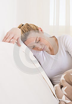 Vertical shot of a young female struggling from a headache