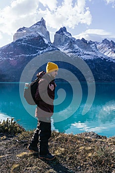 Vertical shot of a young male hiker in Torres del Paine National Park, Magallanes region, Chile