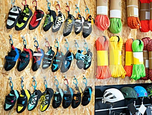 On vertical showcase- trekking shoes for climbing and hiking, colorful ropes and ropes for climbing