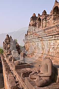 Vertical side View of a row of statues without head at Borobudur