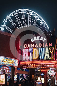 Vertical of a sign of Great Canadian Midway at night on Clifton Hill, Niagara Falls, Ontario, Canada