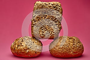 Vertical stack of bread pieces on pink background