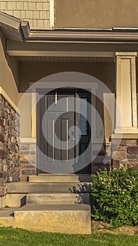 Vertical Stairs leading to porch and front door with sidelight at the entrance of home