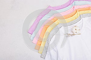 Vertical storage of clothing. Eco spring closet cleaning. Pastel baby T-shirts, sale concept