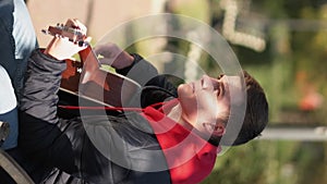 Vertical street performer guitar hobby man playing