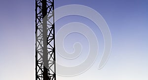 Vertical structure of Tower crane or mast on blue sky background