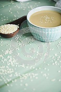 Vertical Tahini Sauce with Sesame Seeds in Wooden Spoon