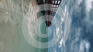 Vertical there is storm brewing over ocean near the pier. Dominican Republic.