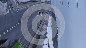 vertical timelapse of movement of cars and vehicles on a winter along highway