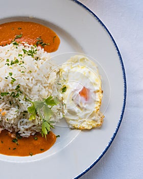 Vertical top view of arroz a la cubana on the table photo