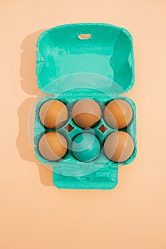 Top view vertical image of blue colored egg basket on a light background