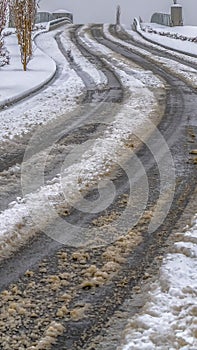 Vertical Tracks on a snowy road in Daybreak during winter