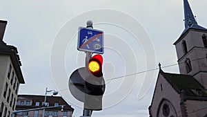 Vertical traffic light with switched red light on city street. Traffic control