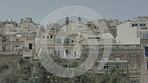 Vertical uplift ,drone flying through beautiful old street, Valletta, Malta. Old, vintage windows, balconies, road, city from top.