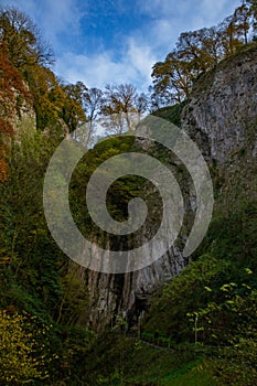 Vertical of the vast and rocky Peak Cavern cave in Castleton, United Kingdom