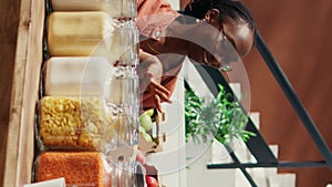 Vertical Video African american seller giving food sample to customer