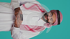 Vertical video Cheerful person messaging on phone