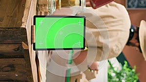 Vertical video Greenscreen on tablet near client