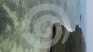 Vertical video house on stilts in the ocean on the coast of Zanzibar, Tanzania, aerial view