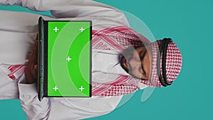 Vertical video Islamic man presents greenscreen on pc